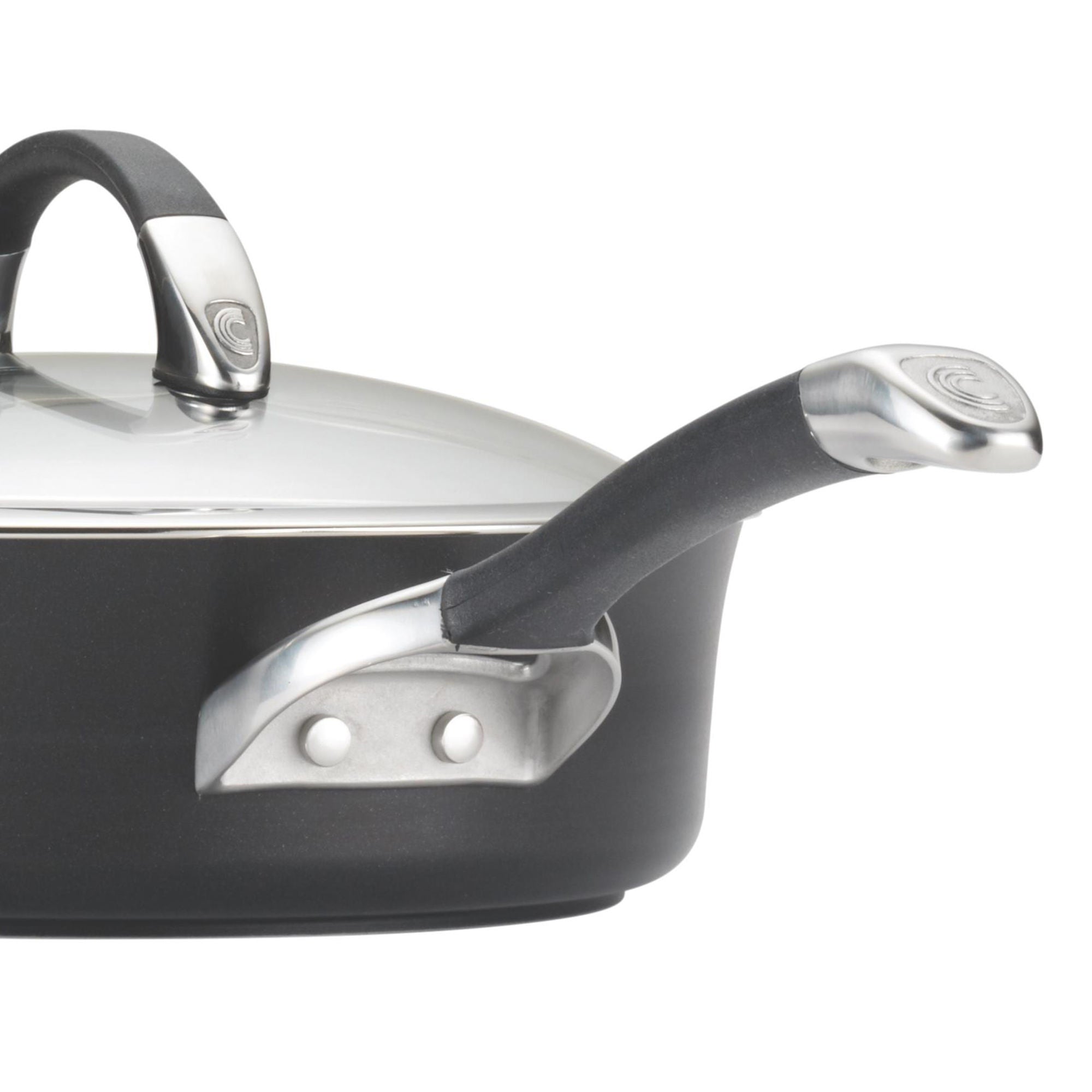 A close-up of a black saucepan with metal handles and a glass lid.