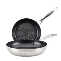 Two non-stick frying pans with stainless steel handles.