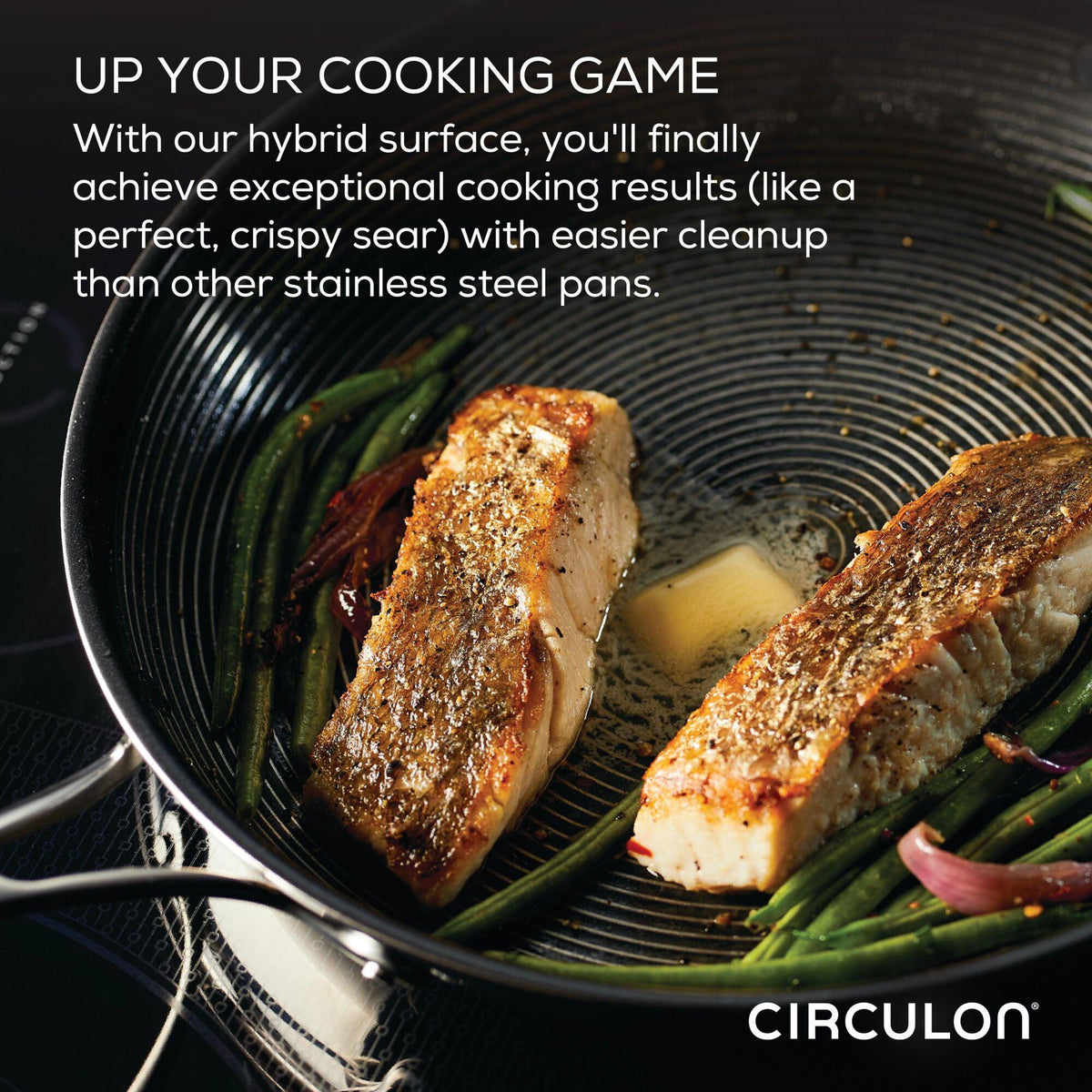 The wok with glass lid and Hybrid SteelShield Technology ensures perfectly seared cooked salmon and green beans sizzling in a frying pan on a stovetop.