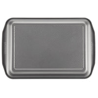 Metallic 9" x 13" rectangular cake pan featuring a textured surface and enhanced nonstick technology.