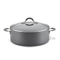 The 7.5-Quart Nonstick Wide Stockpot, crafted from hard-anodized aluminum, is a large gray cooking pot featuring black handles and a glass lid, ideal for preparing one-pot meals effortlessly.