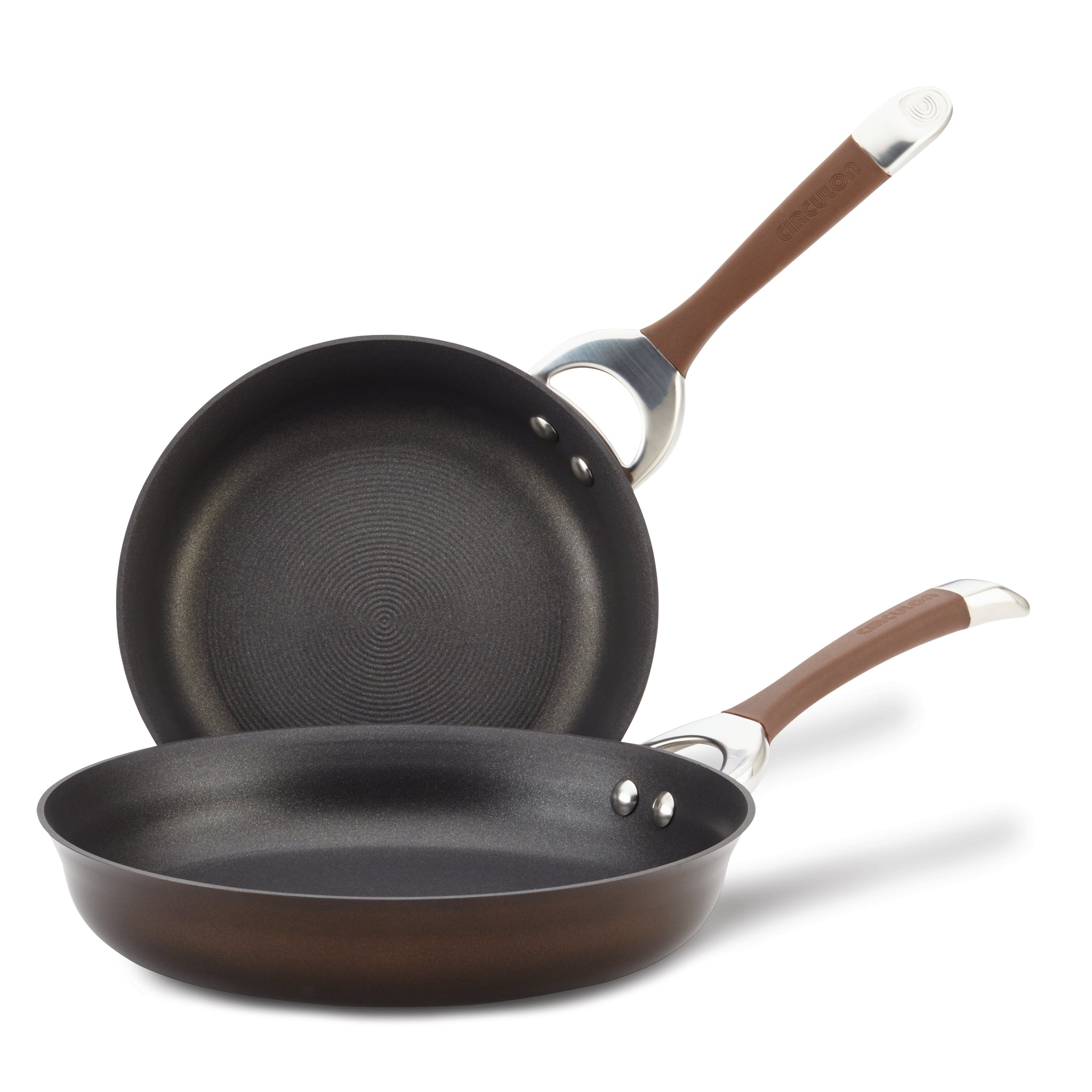 A pair of Hard-Anodized Frying Pan Set with a dependable nonstick system and elegant brown handles, stacked and tilted, ideal for any induction stovetop.