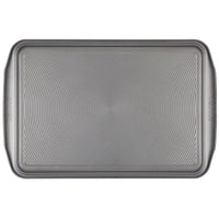 A gray, oven-safe, non-stick cookie sheet from the 2-Piece Nonstick Cookie Sheet Set with raised edges is displayed on a white background.