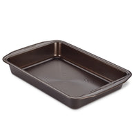 9" x 13" Nonstick Rectangular Cake Pan with a ridged bottom interior crafted in dark metal, featuring advanced nonstick technology for effortless food release.