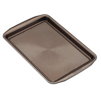 Introducing a rectangular baking sheet from the 5-Piece Nonstick Bakeware Set, crafted from heavy gauge steel. It features a wavy pattern and convenient handles for easy maneuvering.