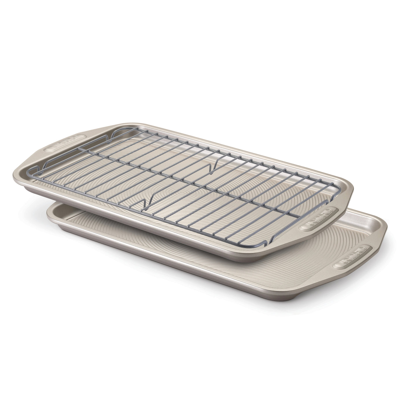 Two beige sheet pans, part of the Nonstick Bakeware Set, featuring a cooling rack on top and a nonstick system for easy baking.