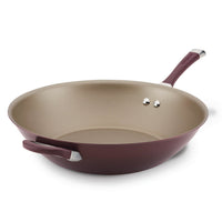 The 14-Inch Nonstick Stir Fry in purple is equipped with a handle and helper handle, featuring a durable non-stick coating achieved through the advanced TOTAL Nonstick System.