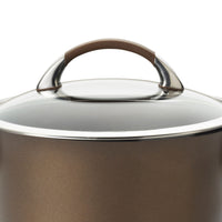 The 5.5-Quart Nonstick Casserole includes a transparent glass cover and a brown handle, constructed from durable hard-anodized aluminum, making it an ideal one pot meal maker for any kitchen.