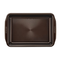 The 9" x 13" Nonstick Rectangular Cake Pan is designed with a metal construction, textured bottom, and convenient handles. It features nonstick technology for effortless cake release and is oven safe to meet all your baking needs.