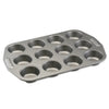 The Nonstick Muffin Pan, crafted from heavy-duty steel to ensure even heat distribution, features a non-stick surface and has a 12-cup capacity on a white background.
