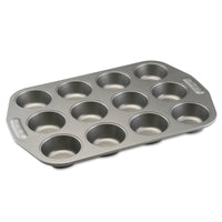 The Nonstick Muffin Pan, crafted from heavy-duty steel to ensure even heat distribution, features a non-stick surface and has a 12-cup capacity on a white background.