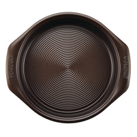 9-Inch Nonstick Round Cake Pan in dark brown with a ridged surface and convenient handles, ideal for crafting oven-safe cake creations.