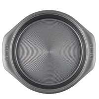 Top view of a round, gray non-stick baking pan with two handles, part of the 5-Piece Nonstick Bakeware Set, crafted from heavy gauge steel to enhance warp resistance.